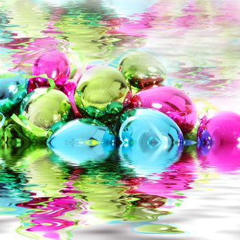 Colourful pink, green and blue Christmas decorations submerged in rippling water with reflections for a beautiful greeting card background