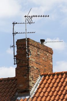 television aerial attached to an old chimney