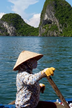 Seller on her boat in Halong Bay, Vietnam