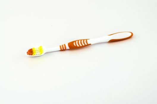 orange tooth brush isolated on white background