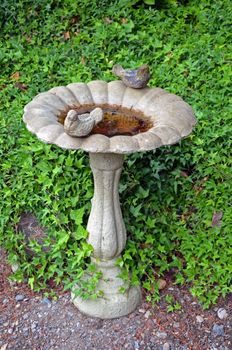 Garden birdbath with stone bird decorations