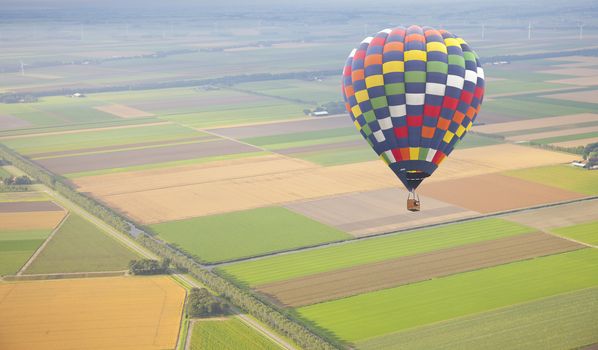 Hot air balloon with green Dutch landscape from above