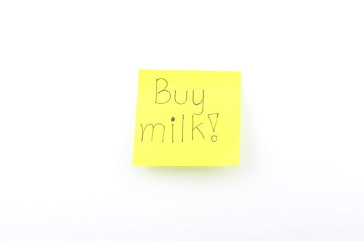 buy milk text on yellow post it isolated on white background
