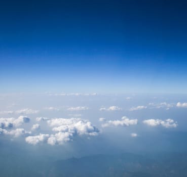 Soft clouds over view from airplane flying