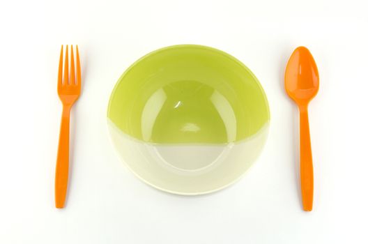 green white bowl with orange spoon and fork isolated on white background