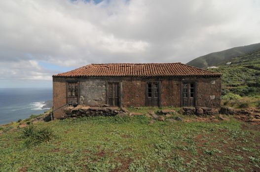 Brown Ancient Rural House on a Cloudy Sky