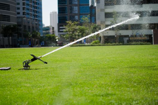 watering in football field on day