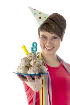 a birthday girl on her 18th birthday, holding a cake with a candle on a white background