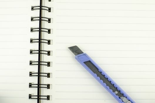 cutter on notebook background texture