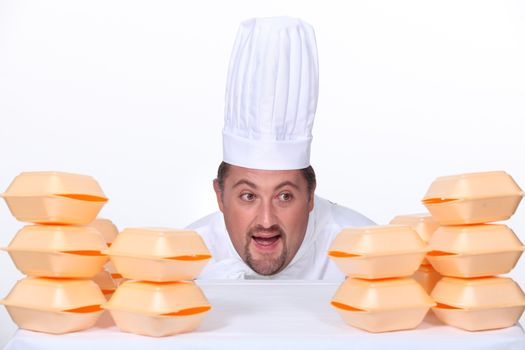 Chef surrounded by polystyrene foam takeaway boxes