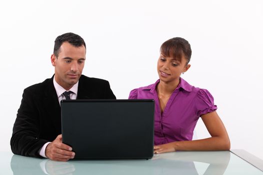 Businesspeople looking at a laptop