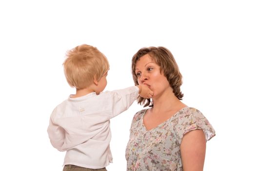 Young boy giving a candy to her mother.  Isolated on white background