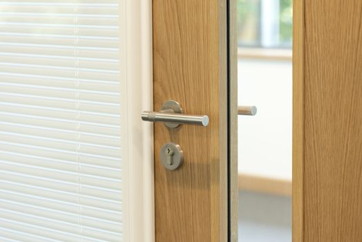 door focused on handle to a modern office