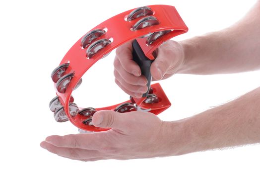 hands playing red musical tambourine on white background