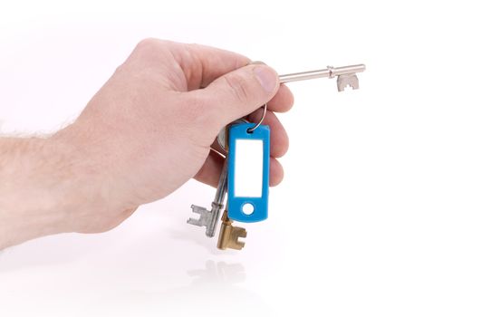 hand holding keys ready to unlock on white background