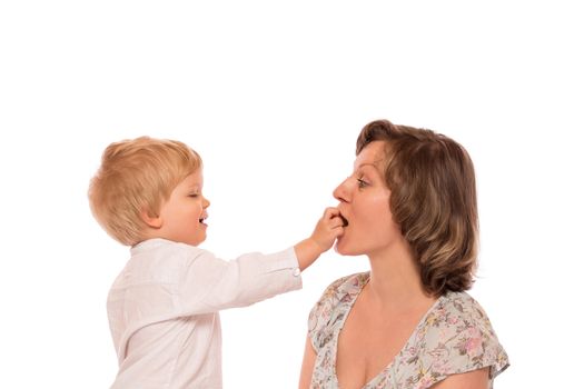 Young boy giving a candy to her mother.  Isolated on white background