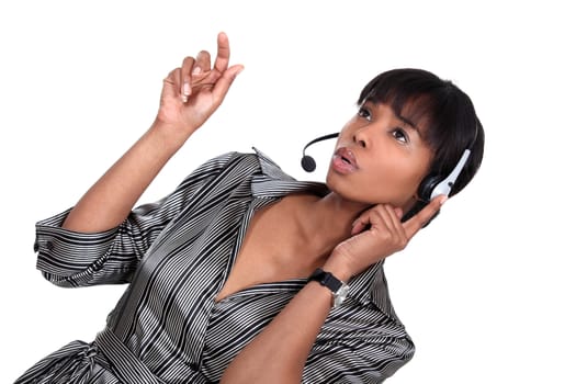 A African American businesswoman with a headset on.