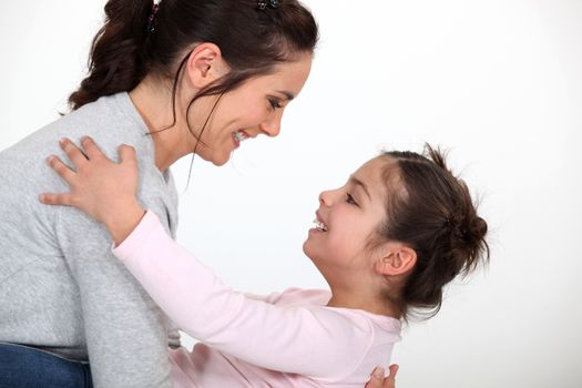 Mother holding daughter