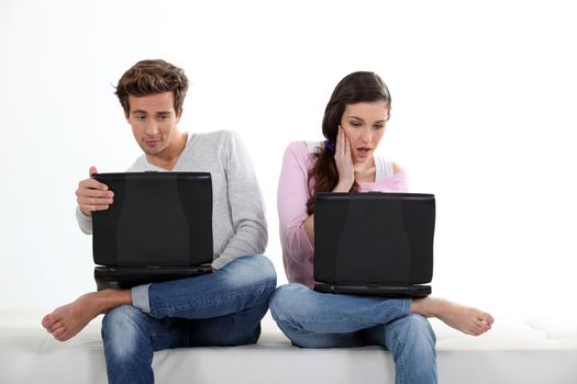 Young couple with their laptops