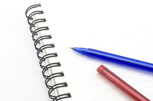 blue and red pen with notebook isolated on white background