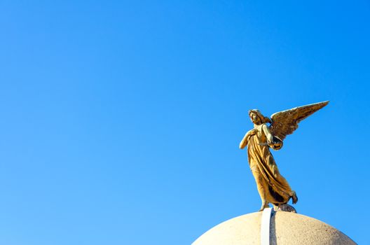 An angel on top of a tomb in the Recoleta Cemetery in Buenos Aires