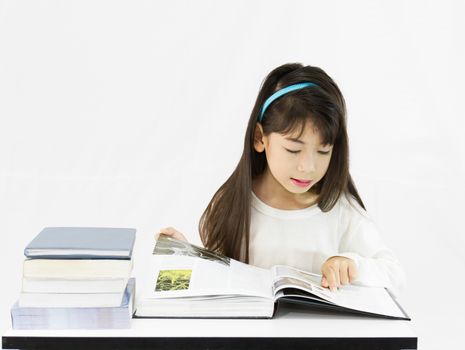 The young student reading the book on a white background