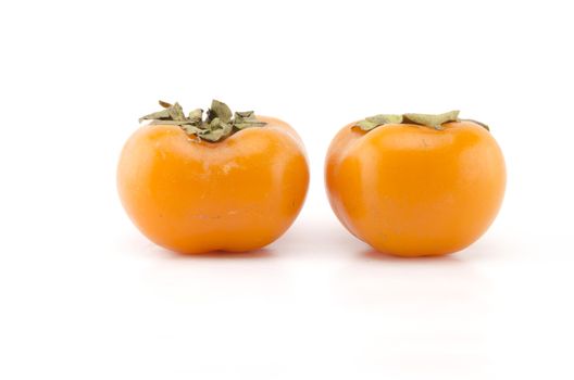 two persimmon isolated on white background