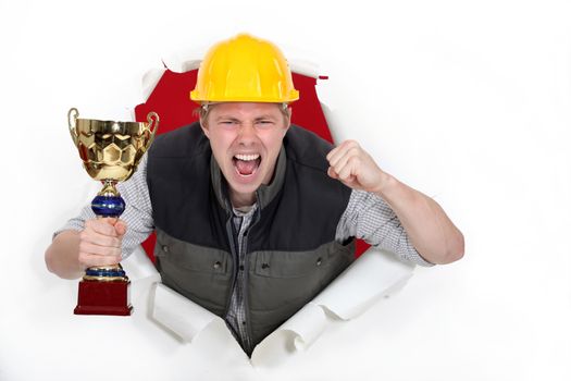 Proud builder holding trophy