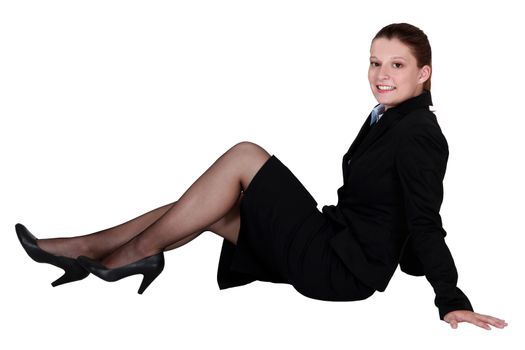 A businesswoman laying on the floor.