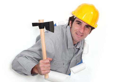 A man popping out a wall in paper with a hatchet.