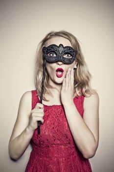 girl in a red dress with a carnival mask