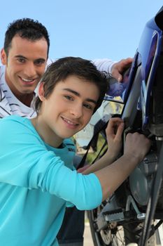 Father and son bonding over motorcycle