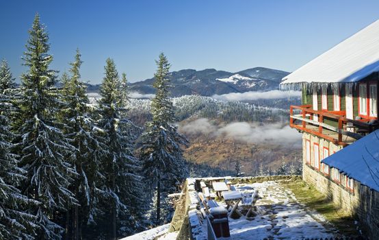 chalet in winter mountain landscape, Romania
