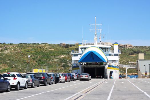 Cars waiting to board a ferry in Gozo, Malta, Europe