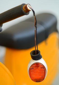A Broken Indicator Light On A Vintage Scooter After An Accident