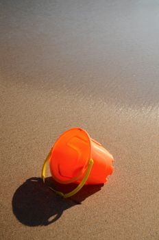 Vacation Image Of A Child's Toy Lying In The Wet Sand Of A Tropical Beach With Copy Space