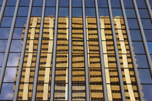 Modern architecture image of an office building reflected in the windows of another building