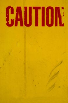 A Dirty, Grungy Yellow Caution Sign With Red Text and Copy Space
