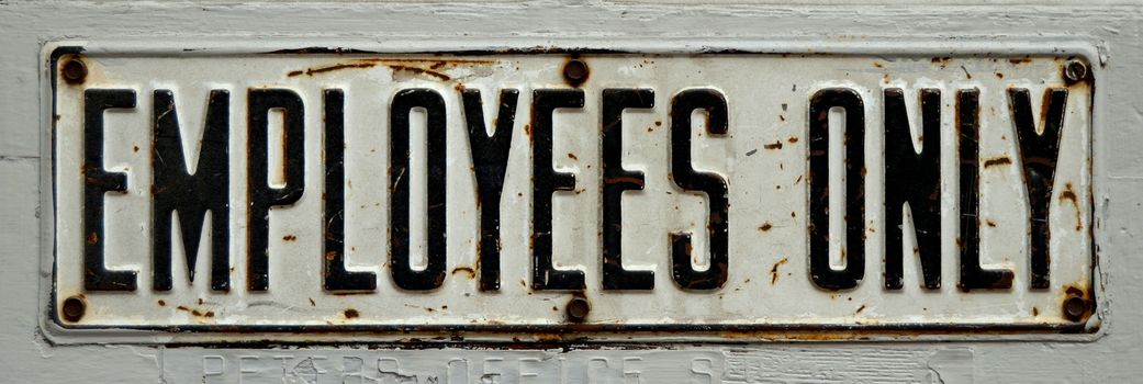 A Grungy, Rusty Old Employees Only Sign