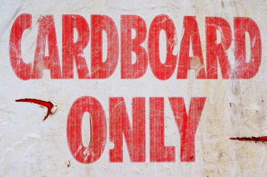 A Grungy Recycling Sign With Cardboard Only