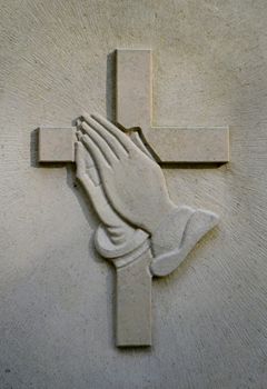 Christian Image Of Jesus' Praying Hands And Crucifix On A Gravestone