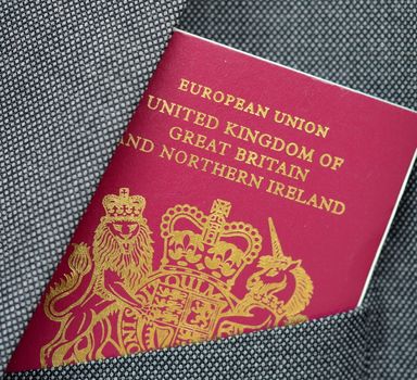 Business Travel Image Of A UK Passport In A Suit Pocket
