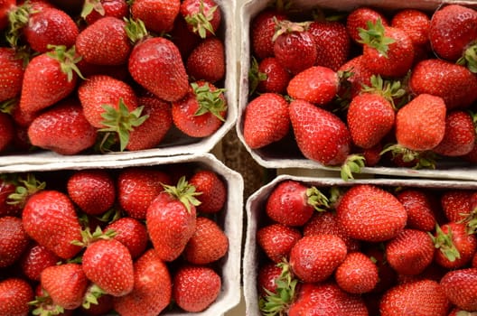 Four Baskets Of Fresh Strawberries In A Street Market