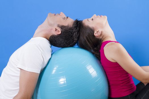 Beautiful athletic couple with fitness ball.