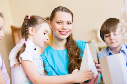 Little children painting and playing at kindergarten