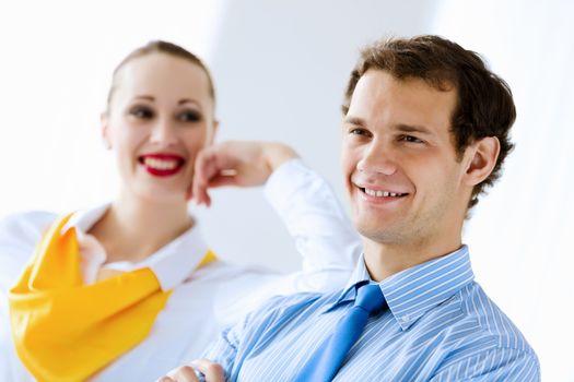 Image of businessman and businesswoman smiling joyfully