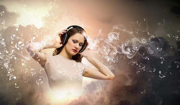 Young girl wearing headphones and listening to music