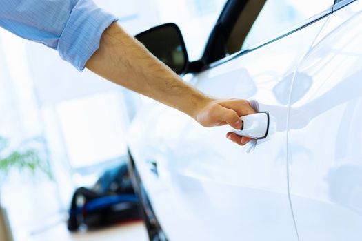 Close up human hand opening car door