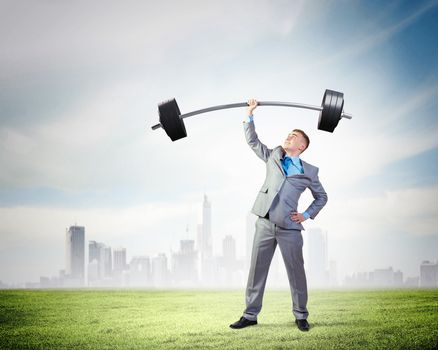 Image of strong businessman lifting barbell above head with one hand