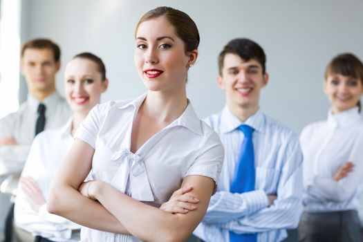 Young smiling businesswoman with colleagues. Leadership concept